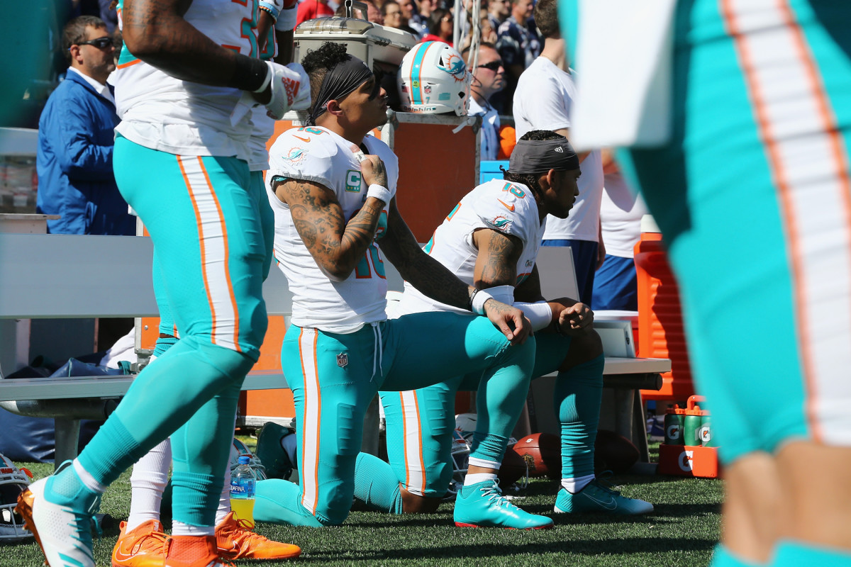 Kneeling, with hand over heart, in Foxborough, September 2018.